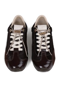 Dark brown sneakers with glossy patent leather and textured fur-like material, featuring cream laces and gold lace hardware accents.