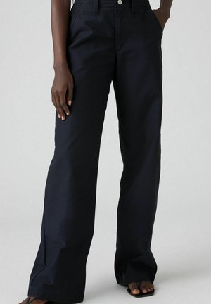 Brede donkerblauwe broek van een katoenmix. Heeft een hoge taille, zijzakken en een nette afwerking langs de zoom.