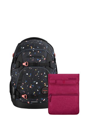 Black backpack with colorful speckles and coral buckles next to a solid magenta pouch with zipper and floral pattern.