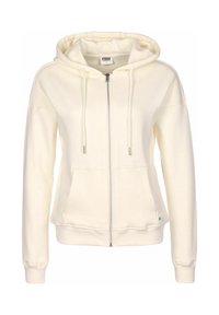 Bílá zipová mikina s přední kapsou, kapucí se stahovací šňůrkou, pružnými manžetami a malým zeleným logem na lemu. Vyrobena z měkkého materiálu.