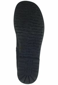 Black rubber shoe sole with a textured, patterned grip. Features deep grooves and a raised logo in the center for traction.