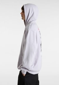 Light purple hoodie with a kangaroo pocket, adjustable drawstring hood, and graphic print on the back. Soft fabric texture and relaxed fit.