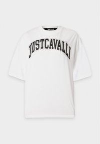 Λευκό oversized t-shirt με μαύρο έντονο κείμενο "JUSTCAVALLI" καμπύλο κατά μήκος του στήθους και κοντά μανίκια.