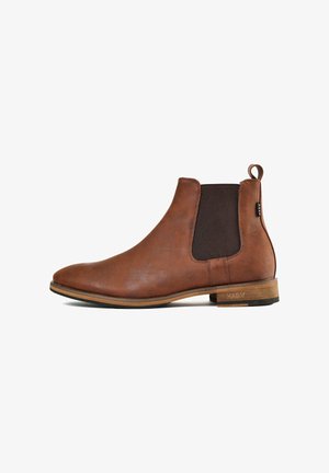 Brown leather ankle boot with elastic side panels, rounded toe, and a pull tab; features a flat heel and contrasting brown accents.