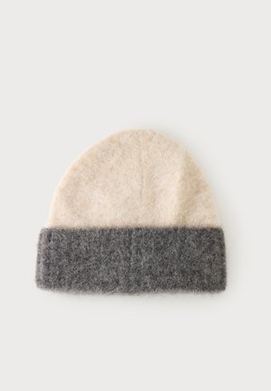 Soft woolen beanie with a beige top and a wide dark gray folded cuff band on a plain background.