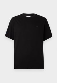 T-shirt noir en coton avec un col rond, des manches courtes et un logo brodé discret sur la poitrine et la manche en noir et bleu.