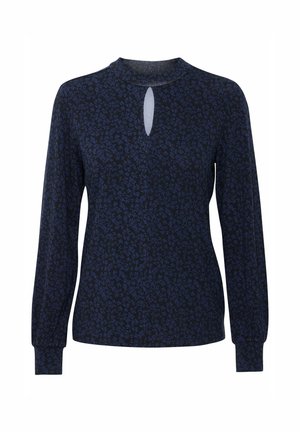 Jūras zila krekls ar garām piedurknēm un ziedu rakstu, ar izgriezumu formā atslēgas cauruma un pieguļošu aproču. Mīksta auduma ar vieglu tekstūru.