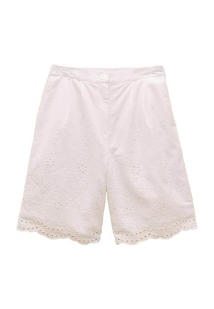 White embroidered shorts with floral cut-outs, scalloped hem, button closure, and pleats. Made from lightweight fabric, ideal for warm weather.