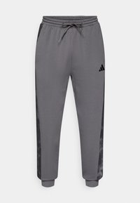 Γκρι αθλητικό παντελόνι από απαλό ύφασμα, με μαύρο πλαϊνό πάνελ και ρυθμιζόμενη μέση με κορδόνι. Λογότυπο Adidas μπροστά.