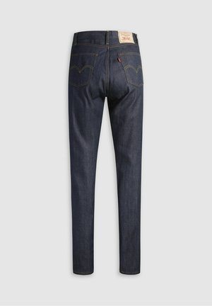 Donkerblauwe denim jeans met een rechte pijp. Opvallende gele stiksels en een leren label op de achterkant van de tailleband. Twee achterzakken.