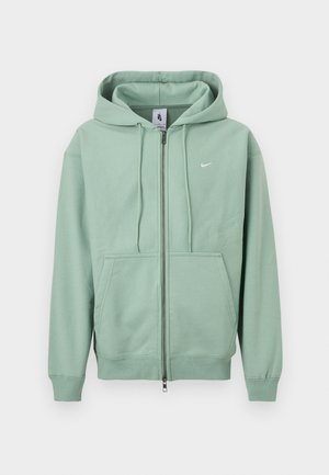 Mint green Nike zip-up hoodie with drawstring hood, front kangaroo pockets, and small white logo on chest.