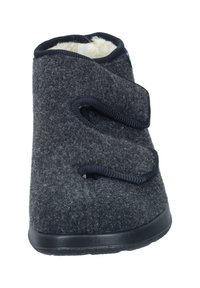 Pantofole grigie in feltro con suola in gomma nera resistente, dotate di due cinturini in Velcro regolabili e rivestimento interno morbido per il massimo comfort.