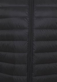 Zwarte donzen jas met verticale doorgestikte textuur, ritssluiting aan de voorkant en glad synthetisch materiaal. Lichtgewicht en warm ontwerp.