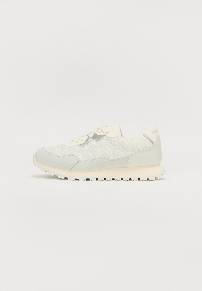 Lichtgrijze textiele sneakers met een geometrisch patroon, crèmekleurige veters en een witte rubbersole, ontworpen voor comfort en duurzaamheid.