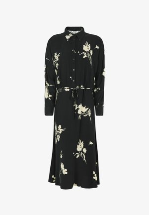 Fekete virágmintás ruha hosszú ujjakkal, gombos elülső résszel és derékszíjjal. Krémszínű virágmintával és légies sziluettel rendelkezik.