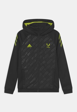 Hoodie zippé noir avec un design texturé, des accents vert fluo et trois bandes sur les manches portant la marque "Messi".