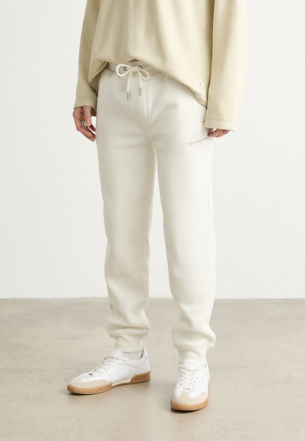 MONOLOGO - Tracksuit bottoms - ivory