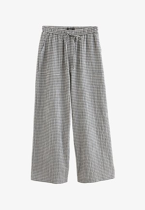 Pantaloni largi cu imprimeu în carouri, din bumbac alb și negru, cu talie elastică și șnur de strângere. Au două buzunare laterale.