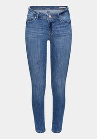 Kapeat farkut keskimäisessä sinisessä denimmissä, joissa on klassinen viiden taskun muotoilu, etupainikekiinnitys ja hienovarainen haalistuminen lahkeissa.