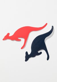 Two kangaroo-shaped pieces made of plastic: one red and one navy. Both feature smooth surfaces and elongated tails, set against a white background.