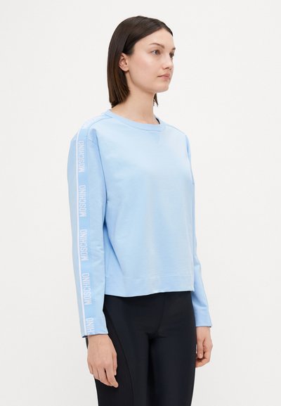 Light blue sweatshirt with long sleeves, crew neckline, and logo detail printed along the left sleeve. Soft cotton fabric.