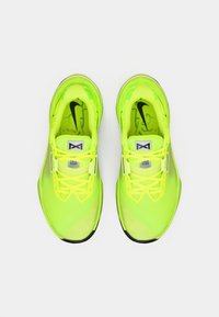 Νεονί κίτρινα αθλητικά παπούτσια με διχτυωτό πάνω μέρος, μαύρες λεπτομέρειες, επίπεδες κορδόνες και υφασμάτινες σόλες. Ελαφρύς σχεδιασμός για βέλτιστη απόδοση.