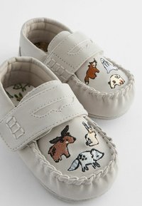 Gray suede loafers with a rounded toe, featuring colorful animal embroidery on the vamp and a Velcro strap for fastening.