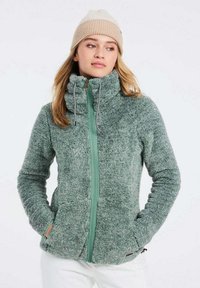 Giacca in pile di un verde morbido con zip intera, colletto alto e tasche laterali. Presenta una zip di un verde chiaro a contrasto e un tessuto testurizzato.