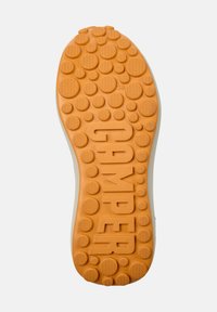 Sole of a shoe with textured rubber surface. Orange color with circular patterns and raised dots. Features the word "CAMPPER" prominently.