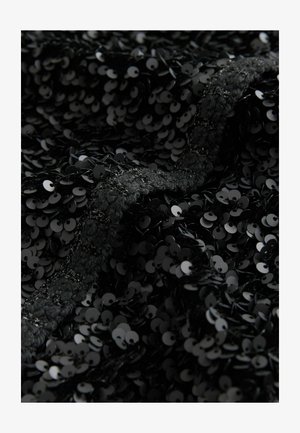 Black fabric covered in overlapping sequins, creating a textured surface. The sequins are shiny, circular, and closely packed together.
