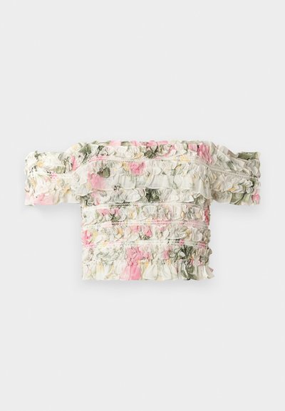 Floral off-the-shoulder top in white with pink and green ruffled patterns. Features slightly elasticized fabric for a fitted look.