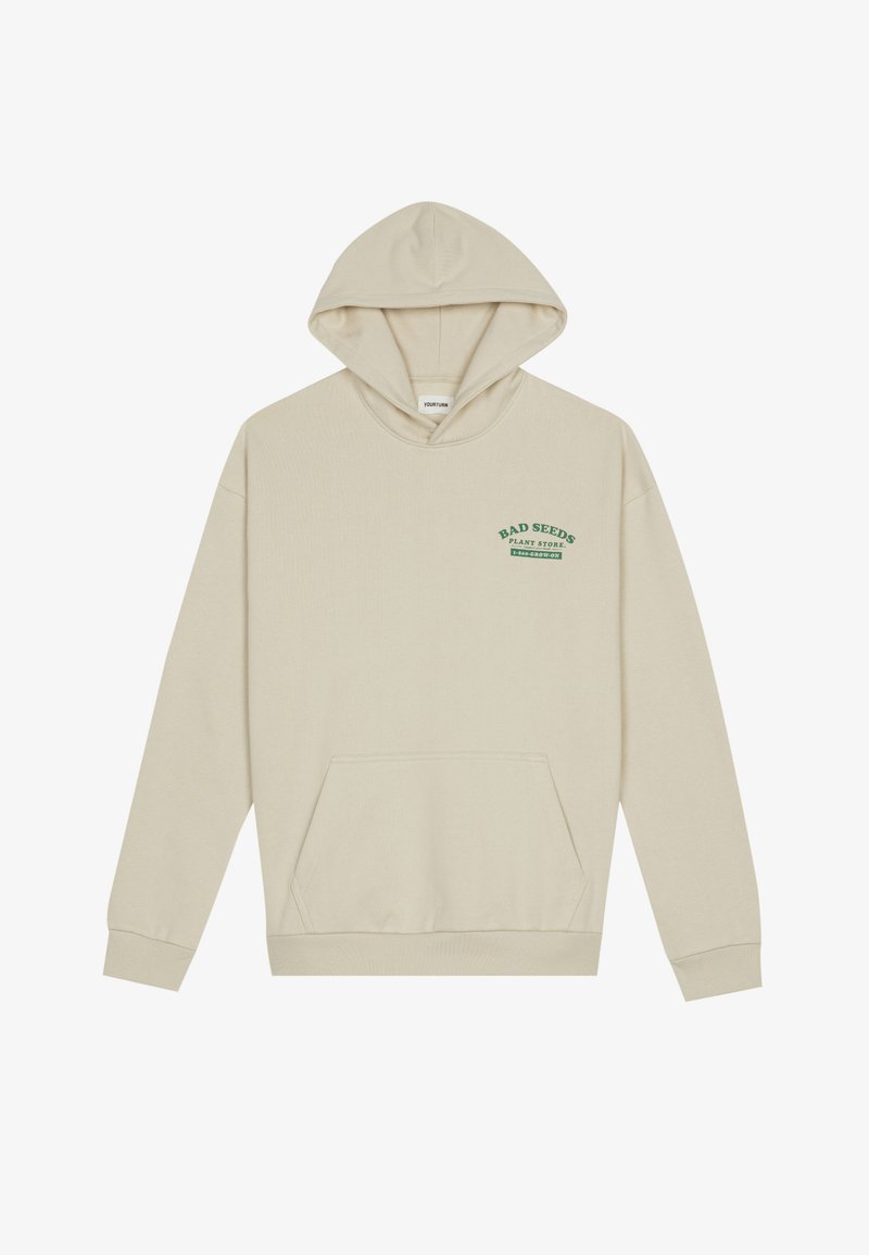 Felpa beige con tasca frontale, che presenta un testo verde che dice "BAD SEEDS PLANT STORE" e "GROW ON." Texture morbida, vestibilità standard.