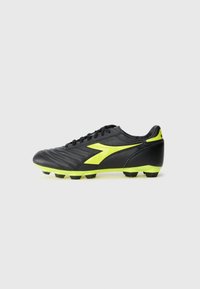 Black soccer cleat with textured leather upper, neon yellow accents on the side and sole, and black studded bottom for traction.