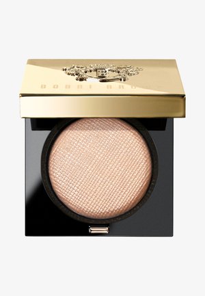 Polvere pressata Bobbi Brown in un compatto rotondo. Coperchio dorato con logo in rilievo, base nera e polvere beige chiara e testurizzata all'interno.