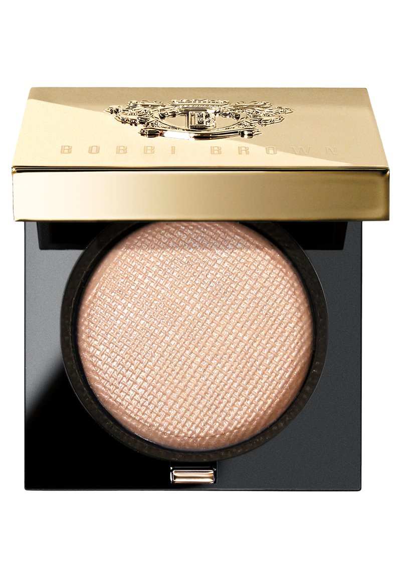 Bobbi Brown pressed powder in a round compact. Gold lid with embossed logo, black base, and textured, light beige powder inside.