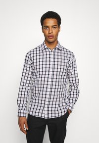 Camicia a maniche lunghe a quadri con un motivo in bianco, blu navy e rosa chiaro. Realizzata in cotone con colletto a button-down e una texture morbida.