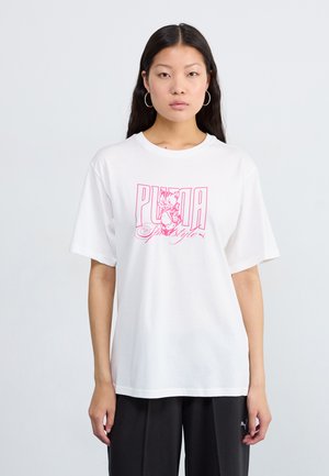 White cotton t-shirt with short sleeves featuring a pink graphic print of a cat and "PUMA" text. Loose fit. Styled with dark pants.