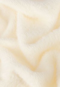 Zachte, pluche stof in een gebroken witte kleur met een fuzzy textuur en subtiele glans, met zachte golvende plooien en zonder patronen of accenten.