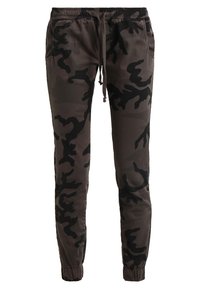 Camo-joggers i mörkgrått med svarta accenter, elastisk midja, dragsko och avsmalnande muddar. Tillverkade av ett mjukt och lätt tyg.