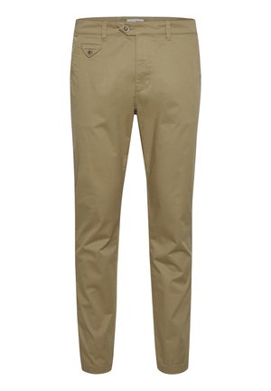 Chinos de algodón beige con corte ajustado, cierre de botón y un pequeño bolsillo decorativo en la parte frontal. Textura suave y diseño a medida.