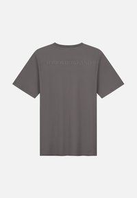 Grijze korte mouwen T-shirt met een ronde hals en geborduurd "TOMORROWLAND"-tekst op de achterkant. Soepele textuur, relaxed fit.