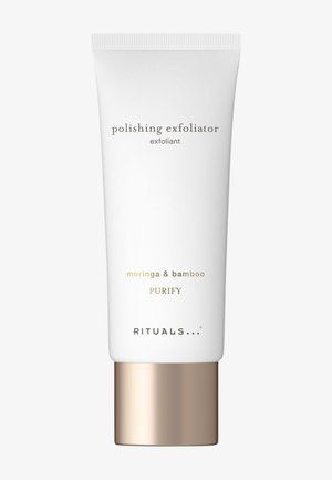 Tube blanc de gommage polissant Rituals avec moringa et bambou, bouchon de couleur or, étiqueté "Purify" sur un fond uni.