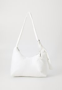 White nylon shoulder bag with a soft, rounded shape, long strap, zip closure, and a detachable small pouch attached.