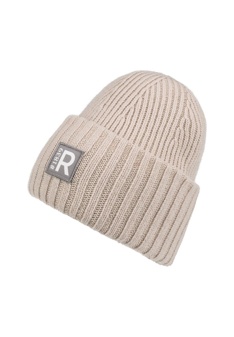 Cream-colored knit beanie with ribbed texture. Features a folded cuff with a gray label showing "#1839" and an "R" logo.