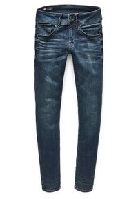 Jeans ajustados de color azul oscuro con ligero desgaste, bolsillos frontales, pasadores para cinturón y cierre de botón.