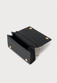 Bolso clutch de cuero negro con herrajes dorados, cuenta con una correa de cadena, dos compartimentos internos y cierre de broche. Textura suave.