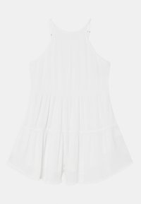 White sleeveless romper with a pleated design and flared bottom. Fabric has a soft texture, featuring adjustable straps and a relaxed fit.