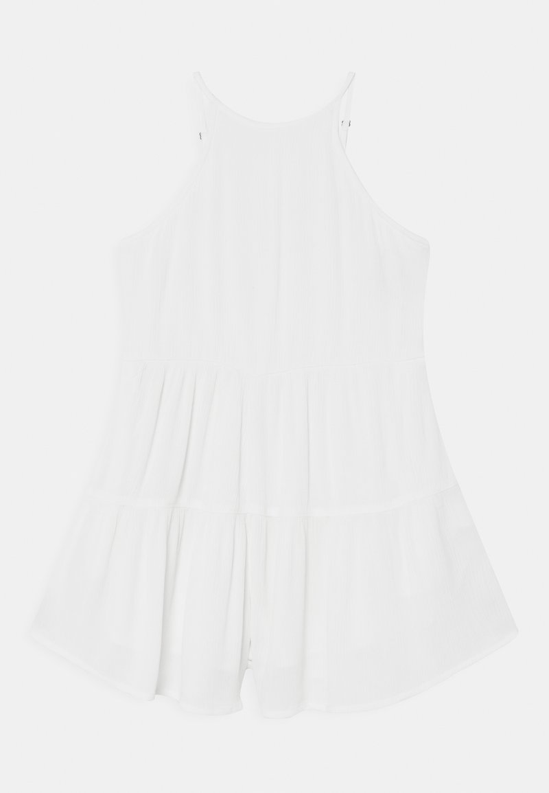 White sleeveless romper with a pleated design and flared bottom. Fabric has a soft texture, featuring adjustable straps and a relaxed fit.