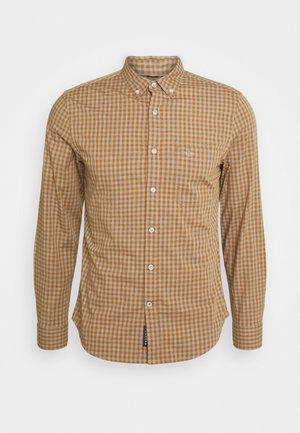 Lange mouw gecontroleerd shirt in bruin en crème, met een button-down kraag, knopen aan de voorkant en een klein embleem op de borstzak.