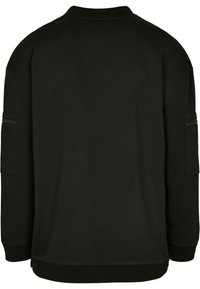 Felpa nera con collo alto, maniche lunghe e una tasca con cerniera sulla manica sinistra. Tessuto liscio con vestibilità comoda.